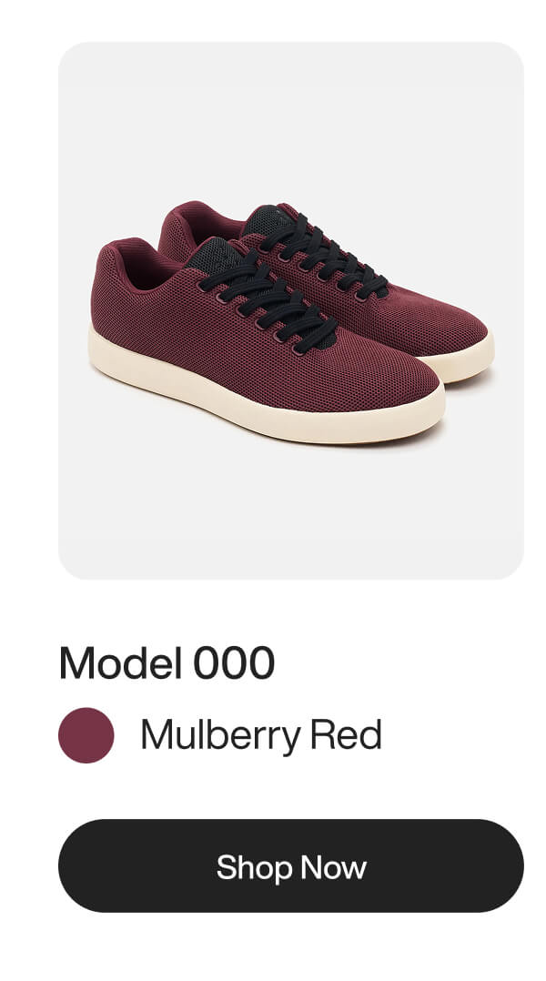 A pair of mulberry red knit sneakers with black laces and a thick white rubber sole.