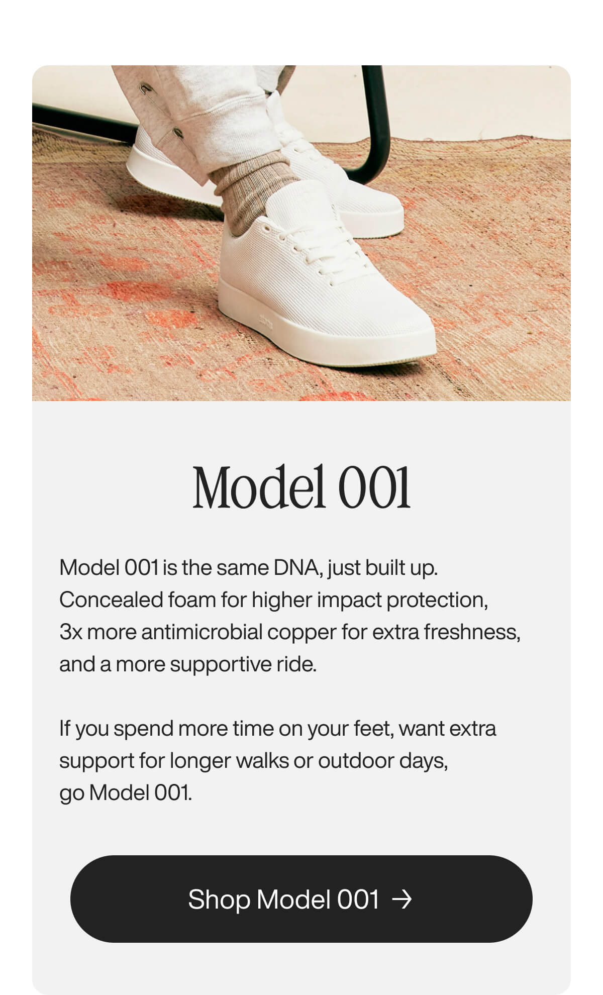 White sneakers with textured fabric are worn by a person in light beige sweatpants, standing on a rustic orange rug. Advert for "Model 001".