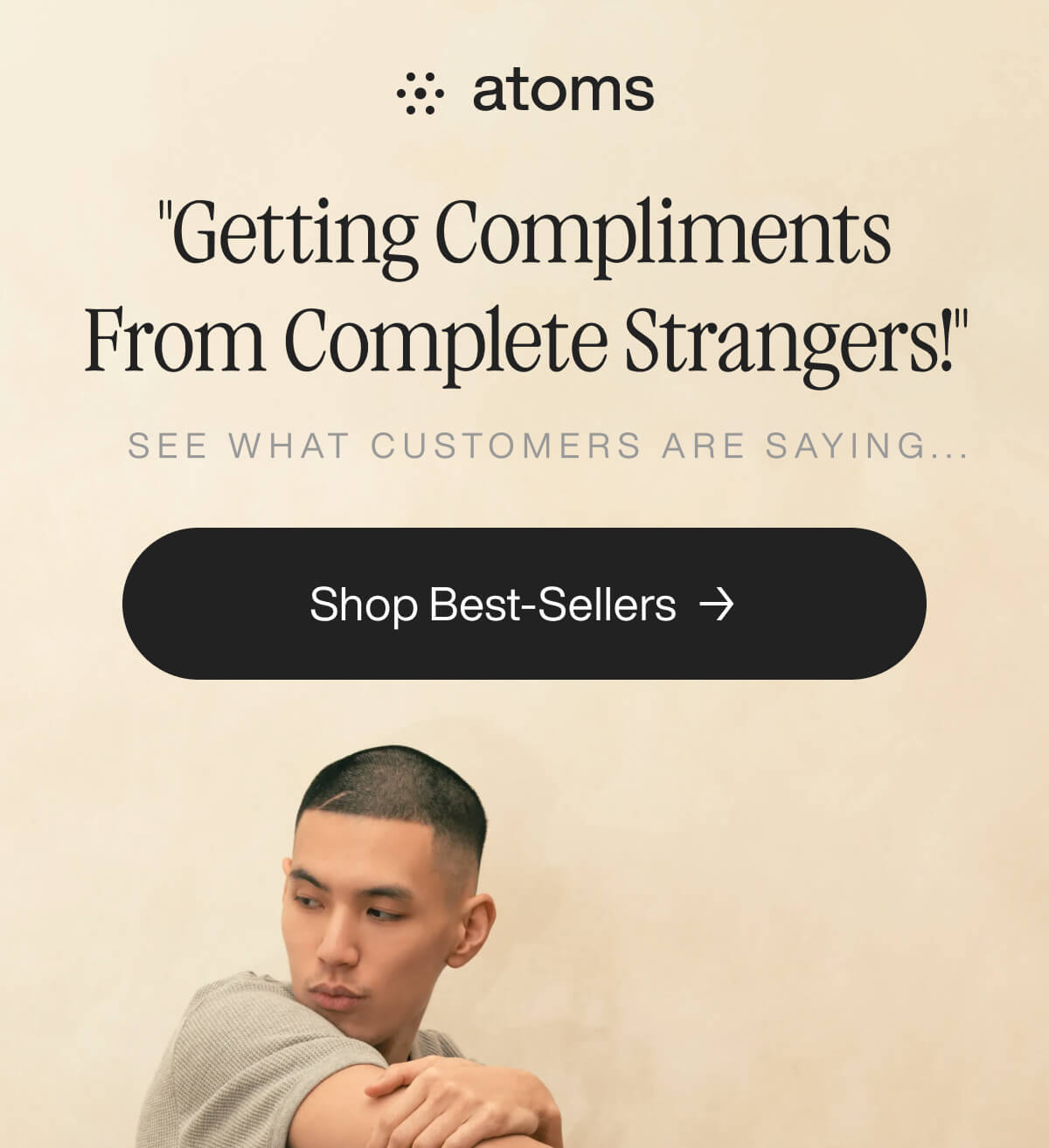 "Atoms ad with a man in a beige shirt, text "Getting Compliments From Complete Strangers!" and "Shop Best-Sellers" button."