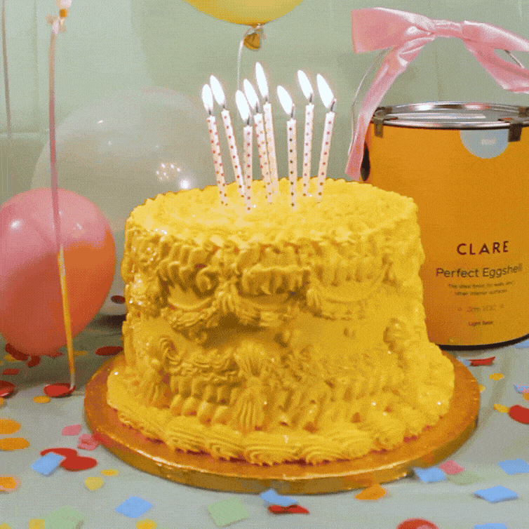 Birthday vignette featuring balloons, confetti, yellow monochrome cake and Clare can
