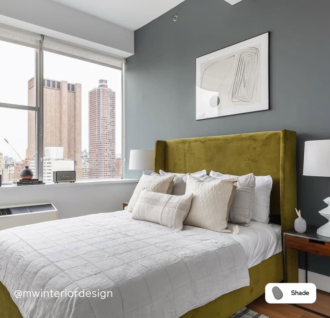 Bedroom with charcoal accent wall featuring paint color Shade