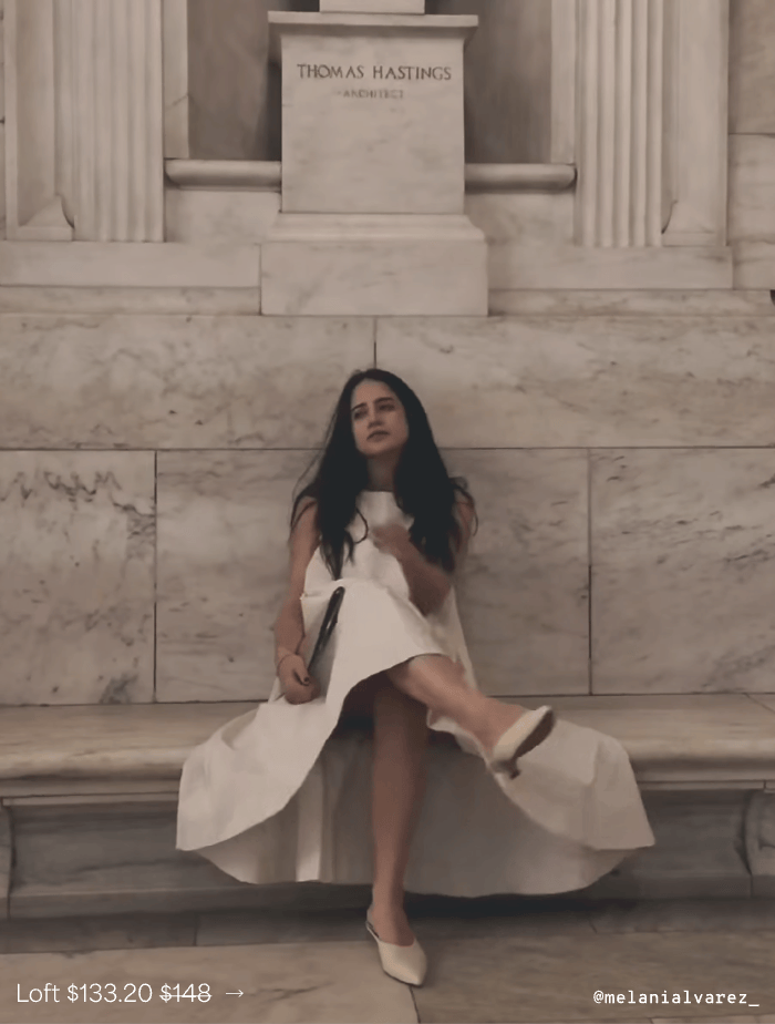 @melanialvarez_ in a cream Loft Dress sits against a marble wall in pointed shoes, featuring the dress for $133.20.