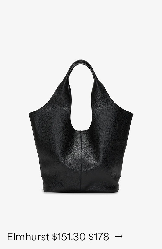 The Elmhurst Tote with a sculptural silhouette, wide body, and oval cutout handle is displayed against a white background
