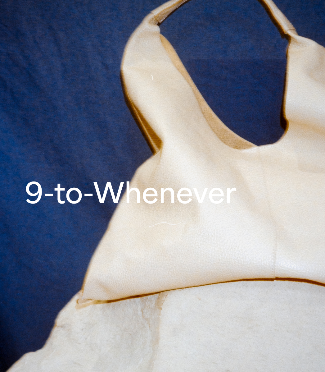 A bone pebble Kelly Tote with a curved silhouette and wide strap rests against a deep blue textured background, with visible text reading “9-to-Whenever.”