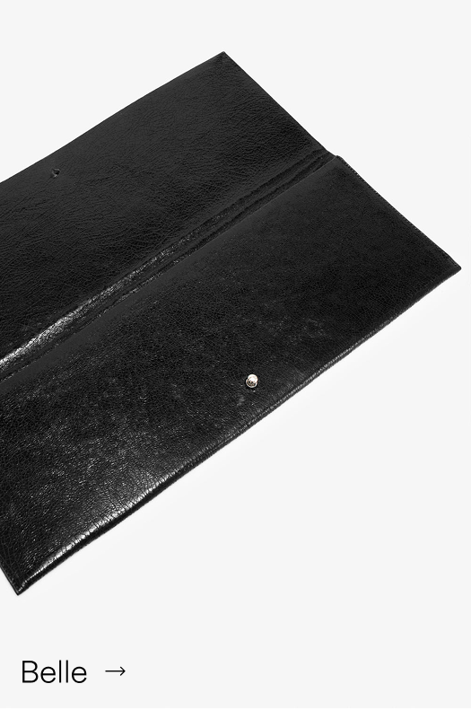 Open Belle Clutch in Onyx, showing its black textured interior.