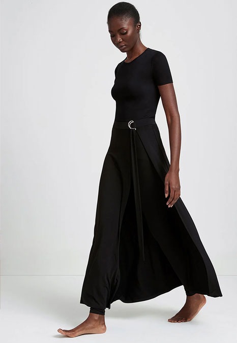 Fatou walks barefoot featuring a black Petite Waverly Pants.