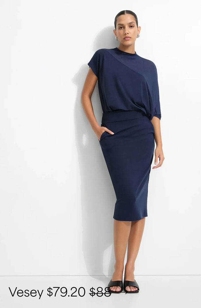 Astrid wears a deep indigo Vesey Pencil Skirt and black heels, priced at $79.20, originally $88.