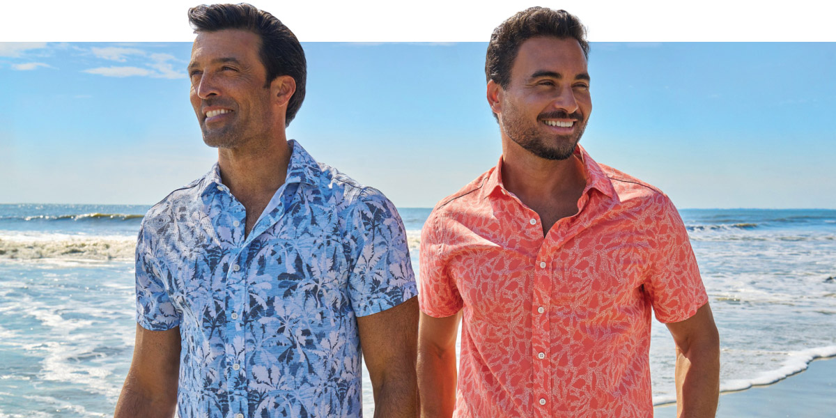 two men on the beach in greg norman vacation shirts