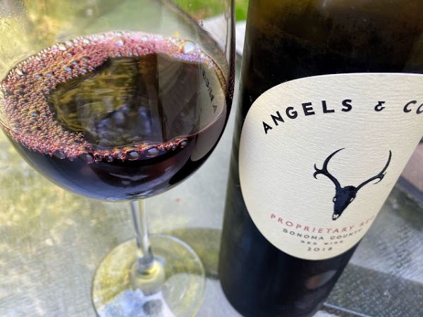 Bottle and glass of Angels & Cowboys Proprietary Red 2018