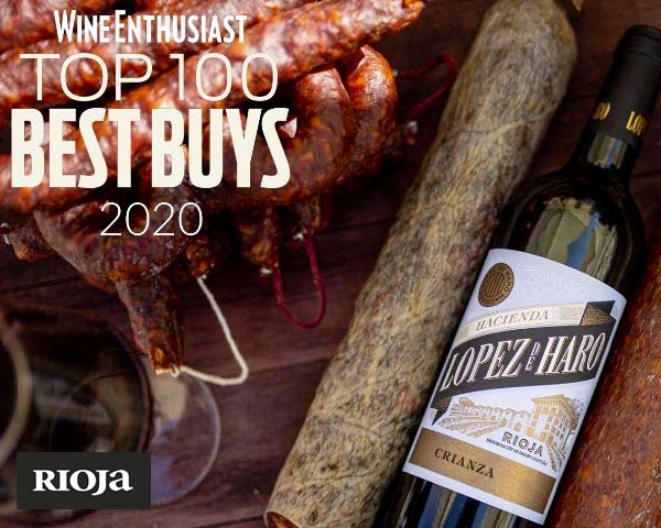 Bottle of Lopez de Haro Crianza lying on a table next to a glass of wine and sausages ready to eat. Text reads, "Wine Enthusiast. TOP 100 BEST BUYS 2020