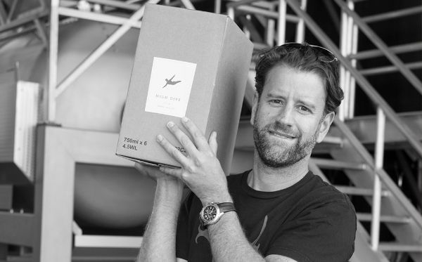 Photo of  Yoav Gilat, producer of Cabernet Sauvignon California by Cannonball 2018 carrying a case of wine.