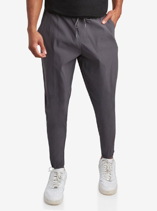 Male model waist down photo of Spyder Track Pants with a light grey studio background
