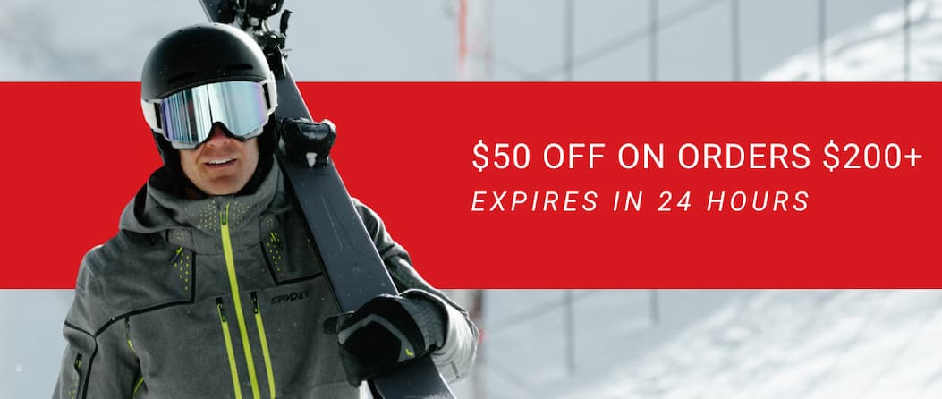 an image of a man holding a pair of skis and a pair of goggles