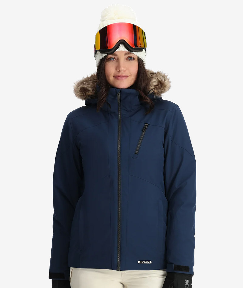 Woman wearing a navy ski jacket with a faux fur hood