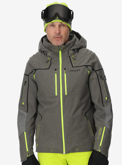 Studio image of model wearing a grey and lime Pinnacle Jacket