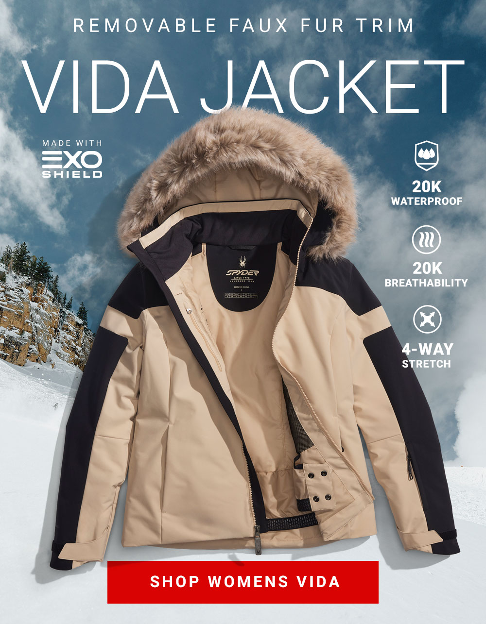 Tan and Black Spyder ski jacket with faux fur trim against a cloud landscape. Message: Removable Faux Fur Trim. Viota Jacket. 20K Waterproof, 20K Breathability. 4-Way Stretch. Made with EXO Shield. Shop Womens Vita.