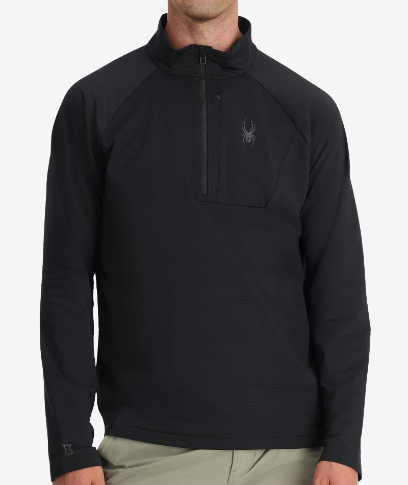 Man in a performance fleece half zip midlayer with a Spyder logo.