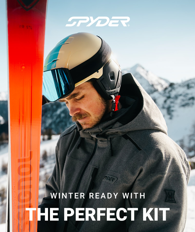 Spyder logo. Skier wearing a grey ski jacket holding a ski in a snow mountain environment. Message: Winter Ready with The Perfect Kit.