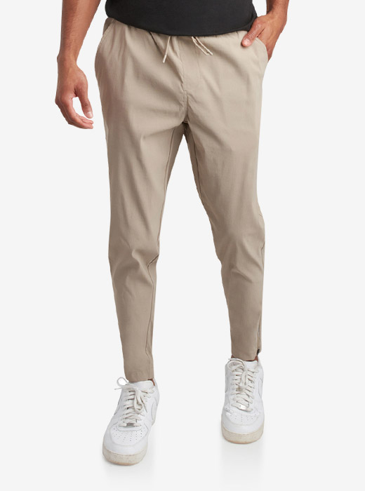 Male model waist down photo of Spyder Track Pants with a light grey studio background