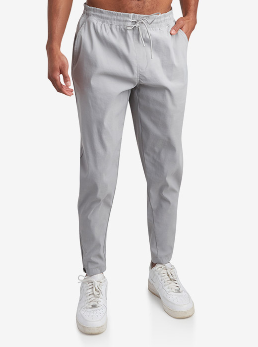 Male model waist down photo of Spyder Track Pants with a light grey studio background