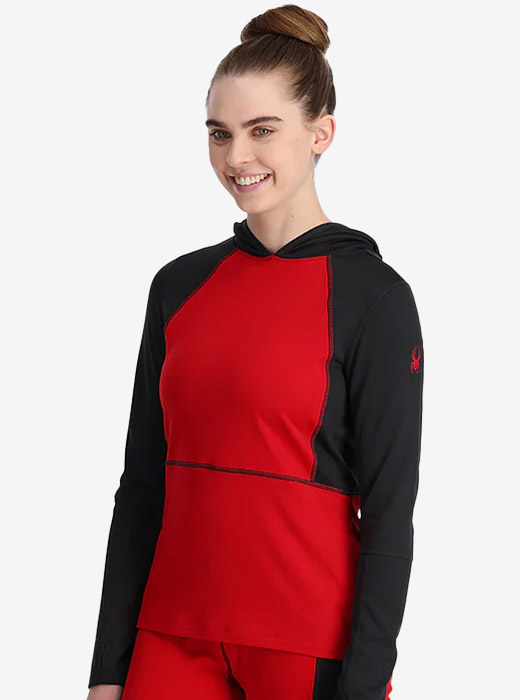 Woman in studio wearing a red and black Spyder baselayer