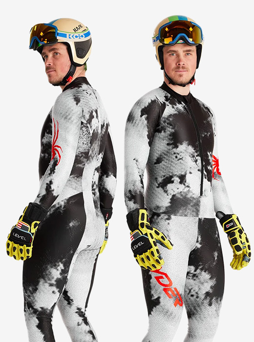 Ski racer in studio wearing a black and white suit with red Spyder logos