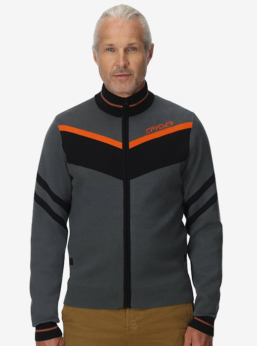 A person wearing a gray sweater with orange and black accents, featuring a zip-up front and sporty design, standing against a neutral background.