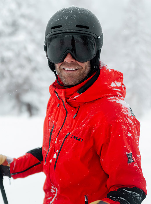 Man in the snow in a red ski jacket. 