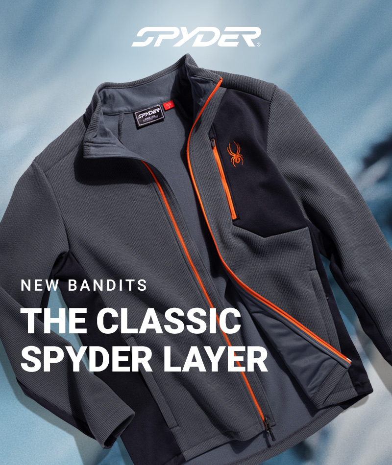 Gray Spyder jacket with orange accents and logo, laid flat on a blue background. Text reads: "New Bandits, The Classic Spyder Layer." Stylish and sporty.
