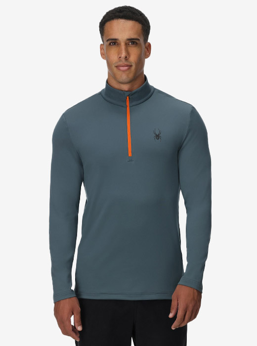 Model in studio wearing a long sleeve half zip in slate blue