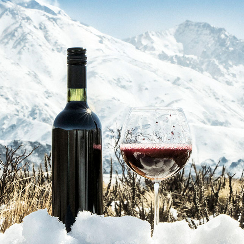 Wine bottle and glass half filled with red wine