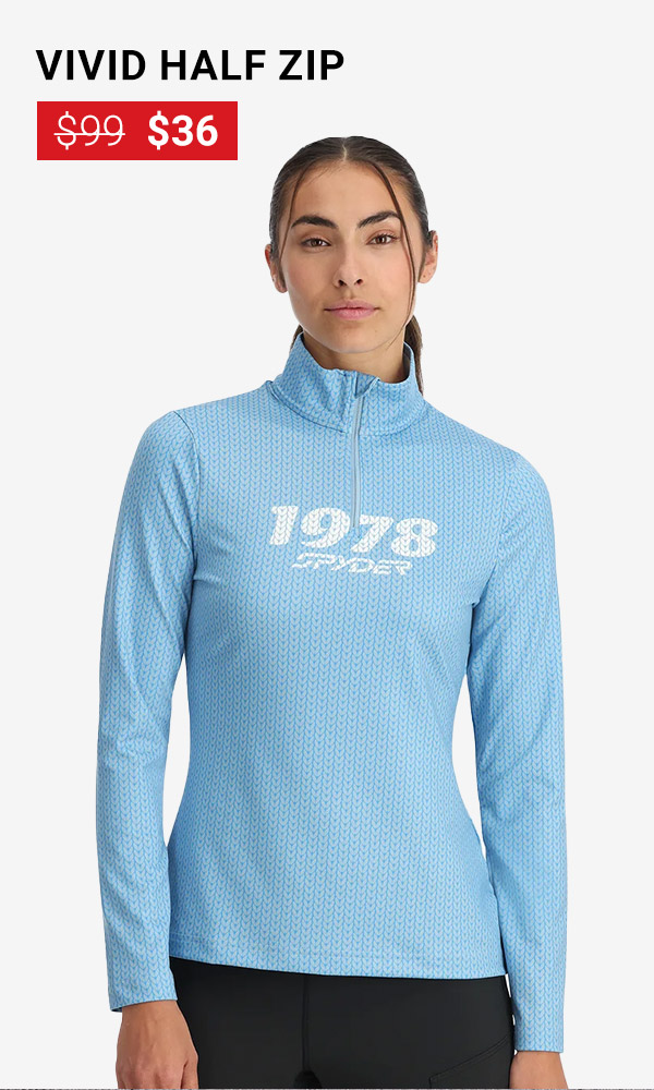 Girl standing in studio wearing a blue ski midlayer that says 1978 Spyder. Vivid Half Zip was $99, now $36