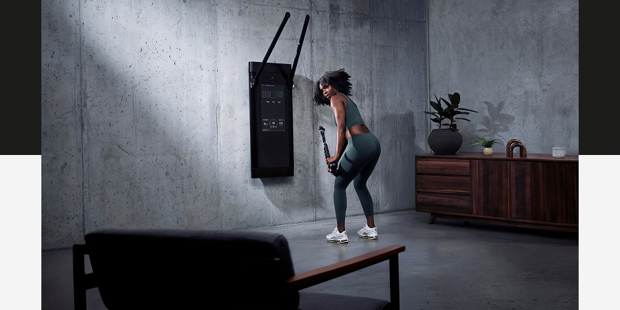 A woman working out with Tonal 2