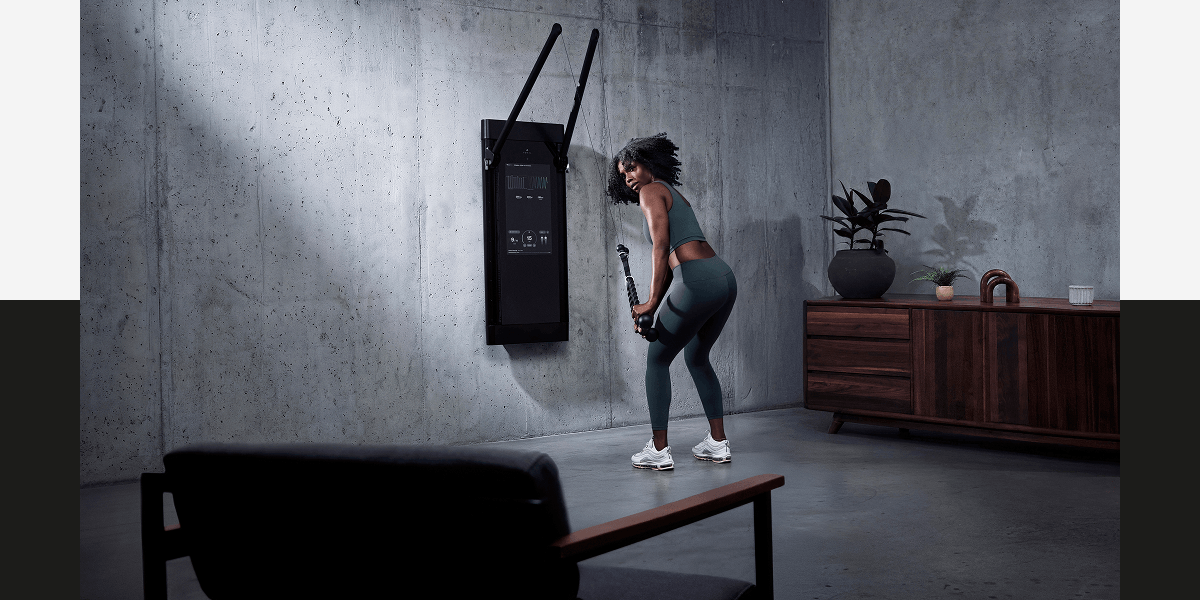 A woman working out with Tonal 2