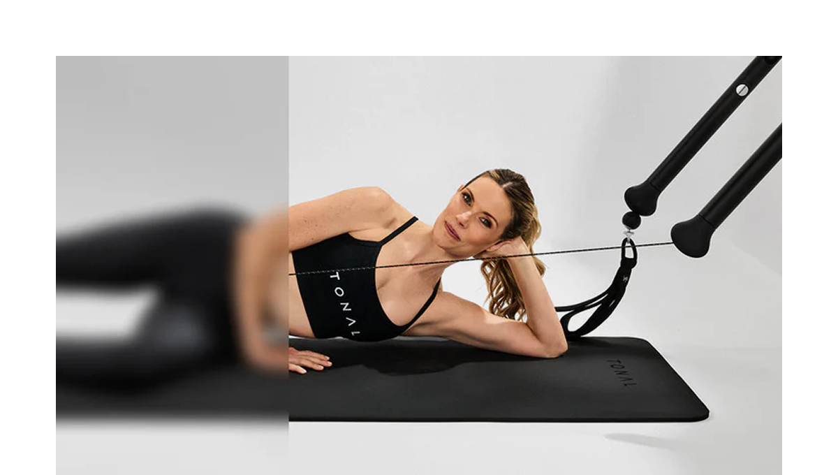An image of a woman working out with Tonal