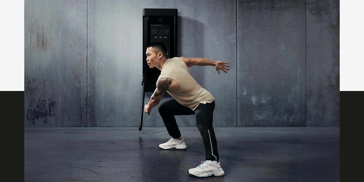 A man working out with Tonal 2
