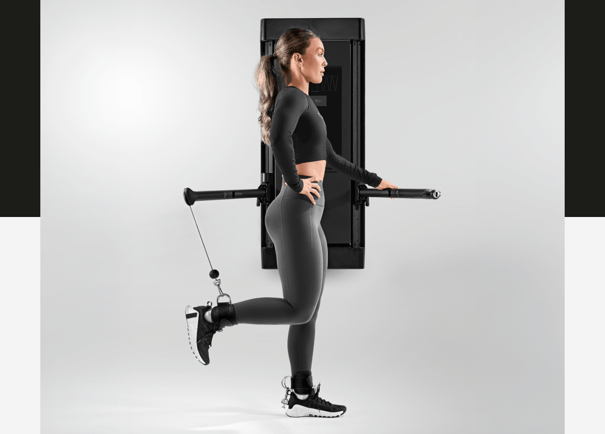 A woman working out with Tonal 2