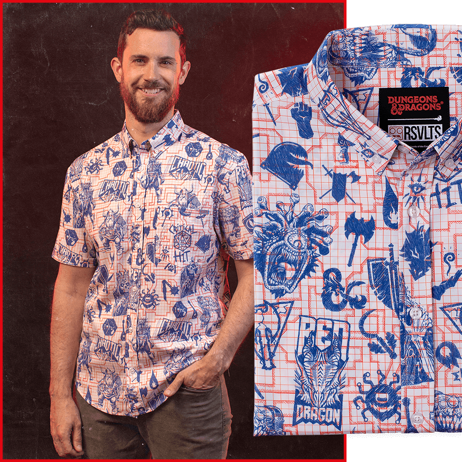A man smiles while wearing "Critical Sketch" shirt. Closeup of the shirt on the right-hand side of the image.