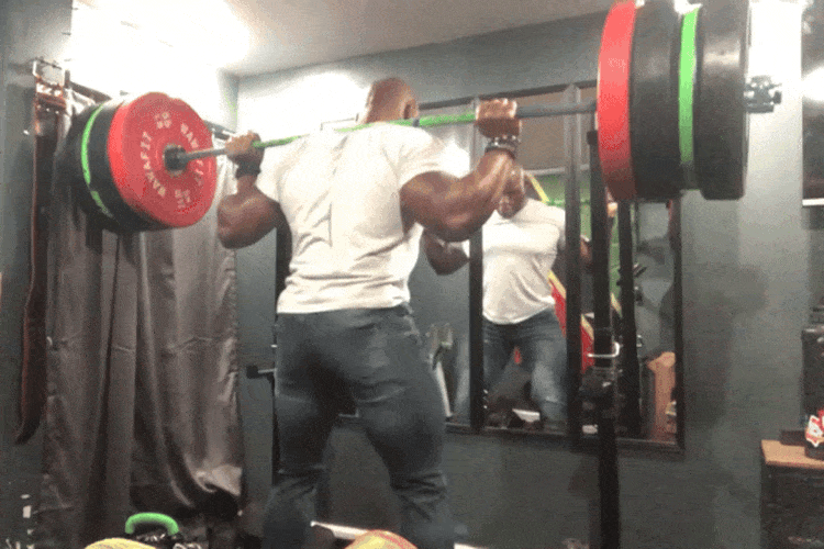 Man in heavy squatting in a White Tee and Athletic fit Knights
