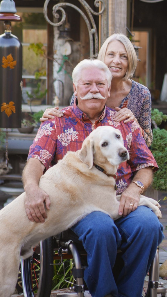 Man wearing Athletic fit Captains with a dog in his lap