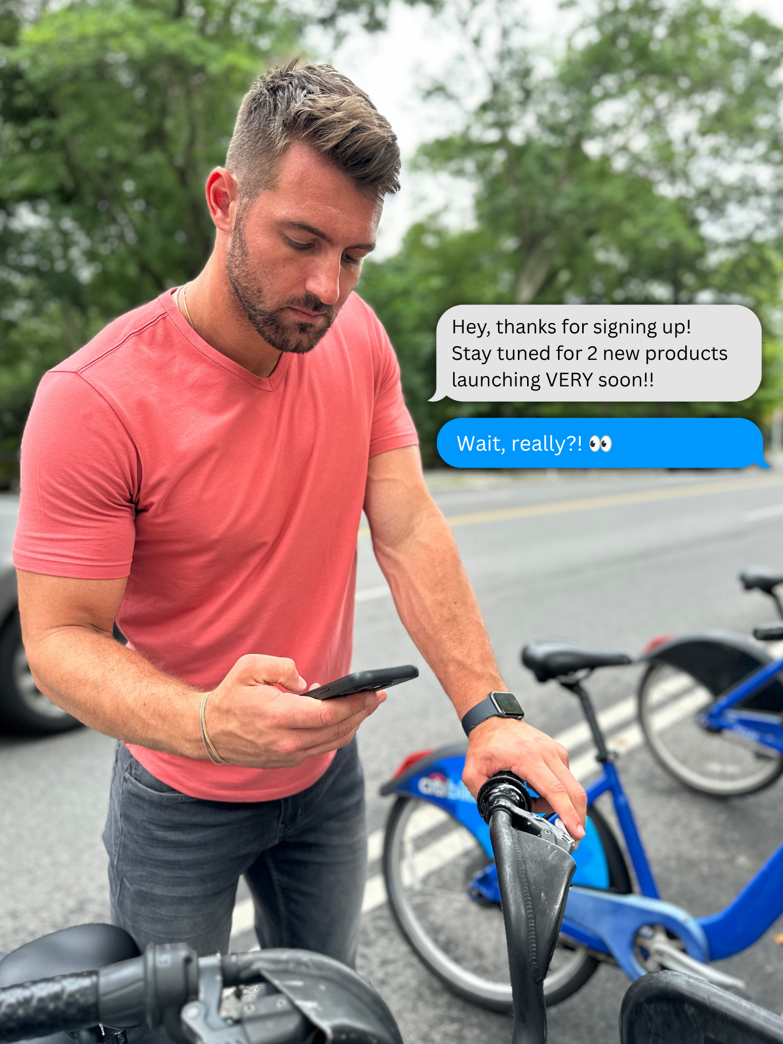 Model checking his phone, wearing a Nantucket Red V-Neck Tee and Slim Thick fit Cowboys