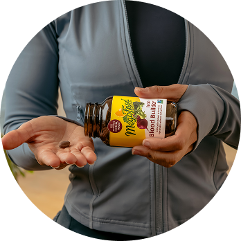 Blood Builder tablet in a woman's hand