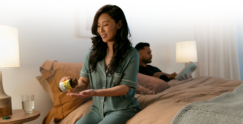 Woman in bed taking magnesium