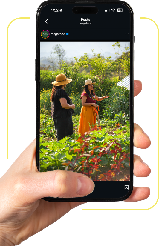 Hand holding mobile phone on MegaFood Instagram featuring Carla Morán | Cooperative Partner, Las Cañadas | Women's Earth Alliance Partner