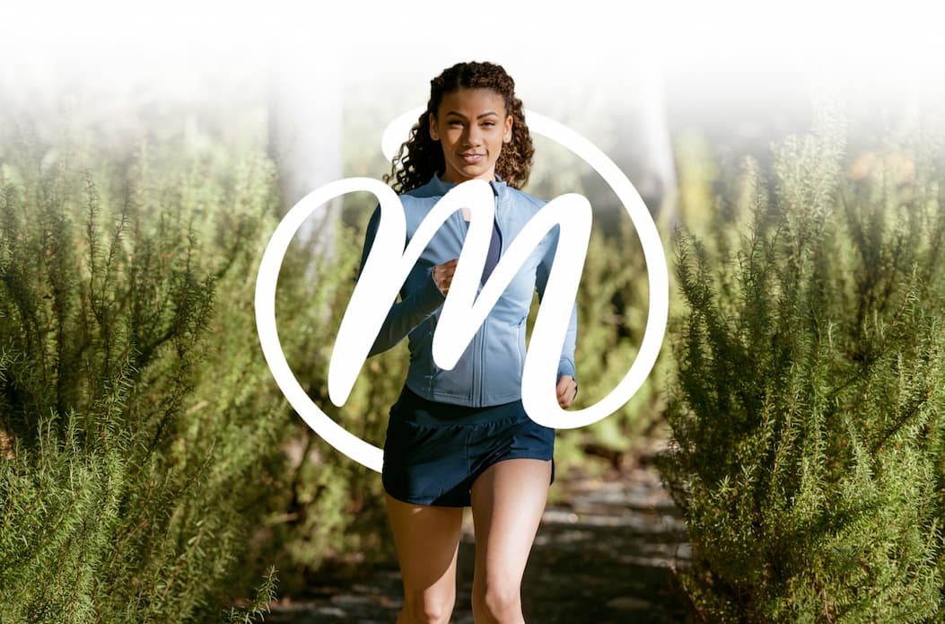 Woman running wrapped in the MegaFood monogram