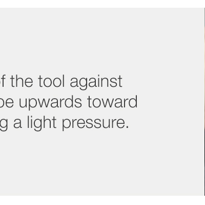 Step 2 - Position the flat end of the tool against the forehead and swipe upwards toward the hairline maintaining a light pressure.
