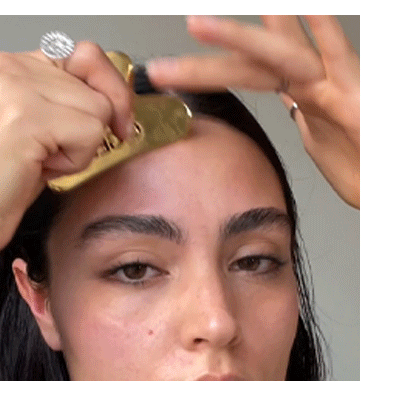 Step 2 - Position the flat end of the tool against the forehead and swipe upwards toward the hairline maintaining a light pressure.