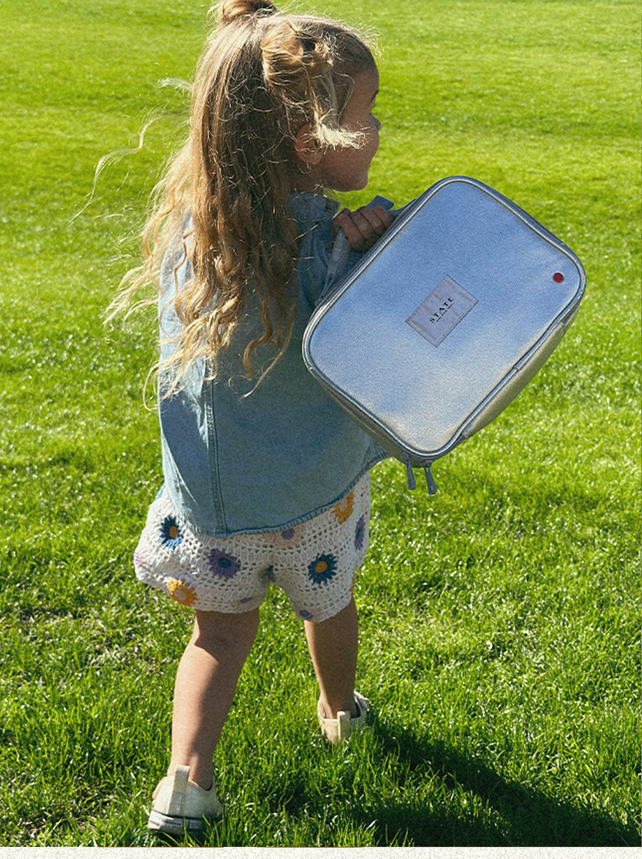 girl holding rodgers lunch box silver
