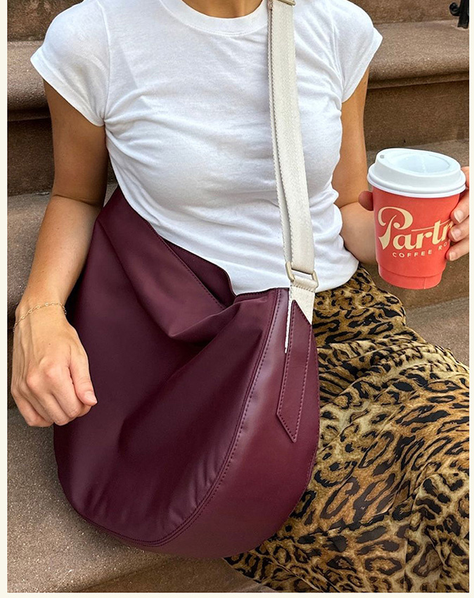 Girl wearing luna crossbody burgundy