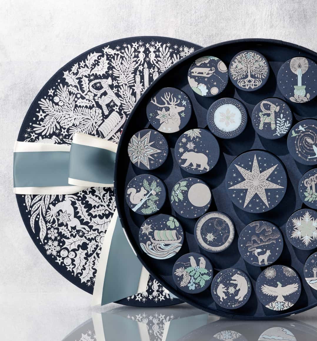 Our navy and silver Advent Calendar, opened to reveal Ornament boxes, whose designs are inspired by Nordic mythology.